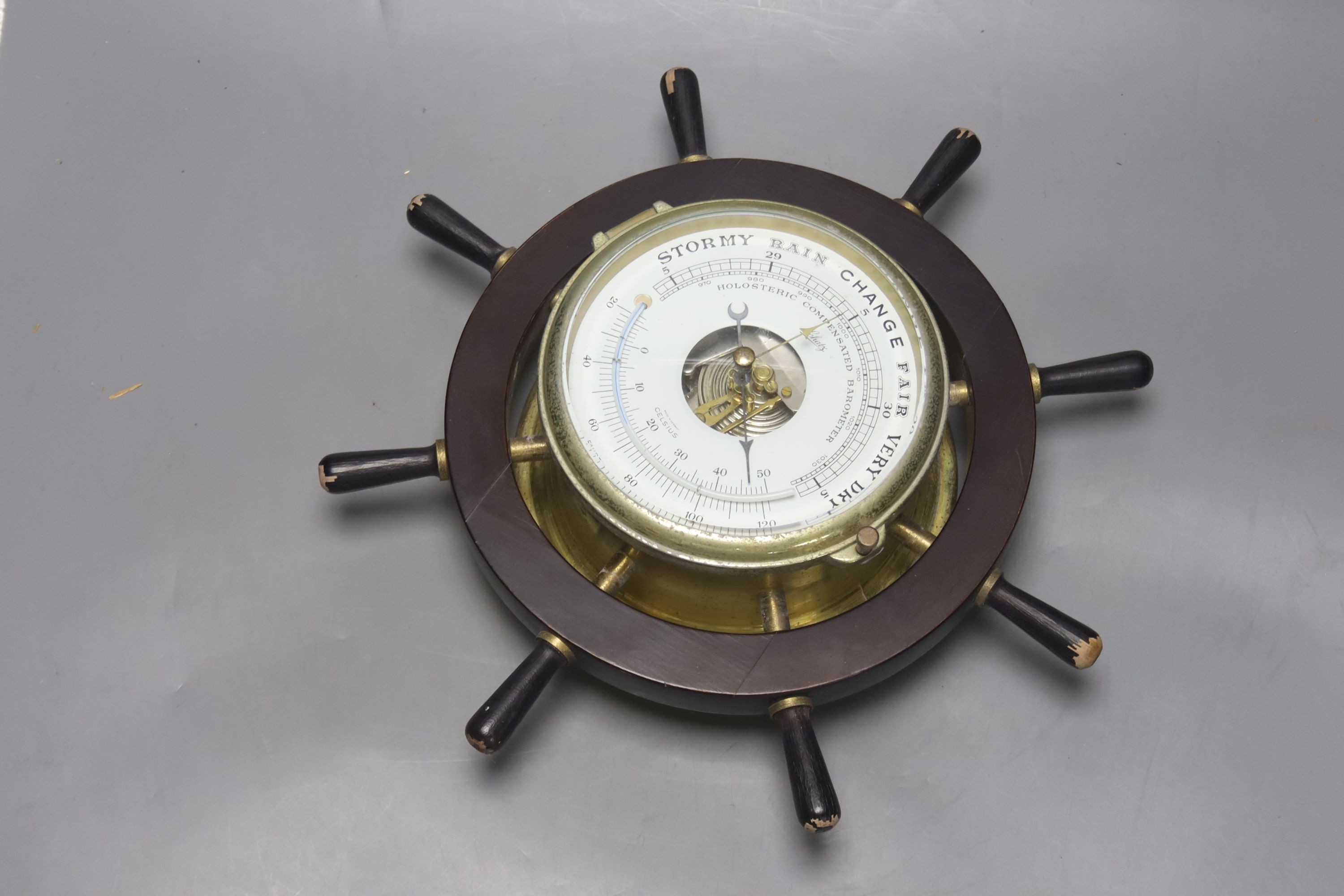 A pair of Schatz marine style wall hanging instruments: a clock and a holosteric compensated barometer, dials 13cm